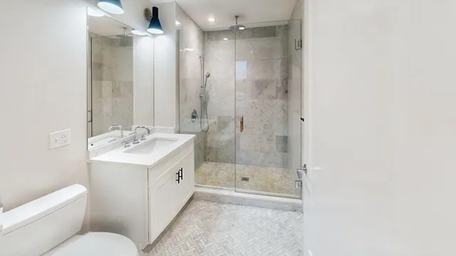 a bathroom with a sink toilet and shower