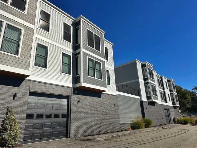 a front view of a building with a yard