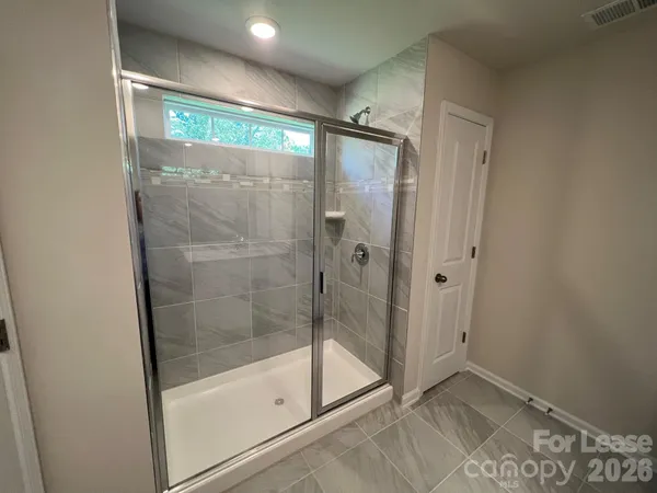 a bathroom with a glass shower door