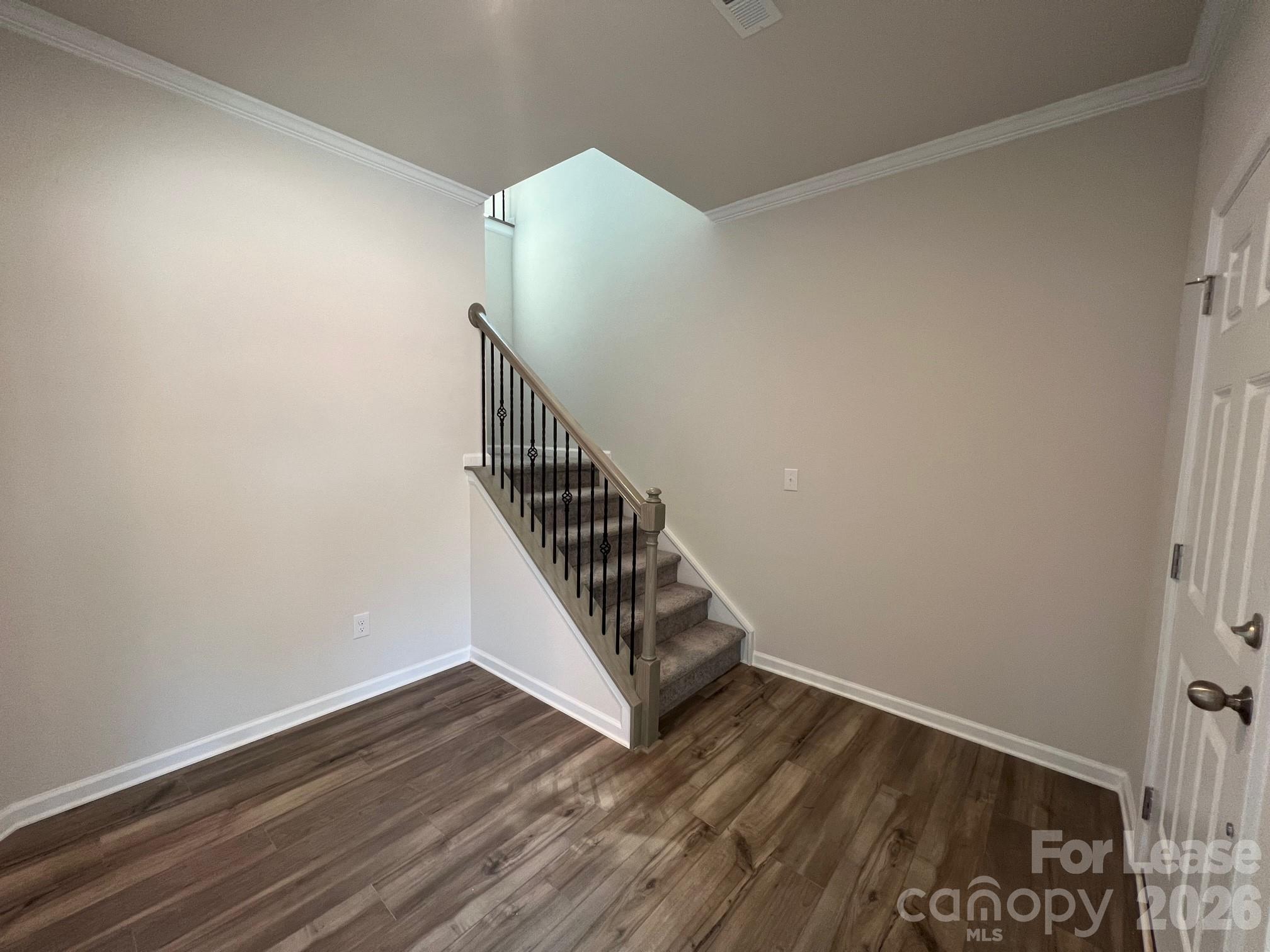 202 Tackle Troutman, NC 28166 - Photo 4 of 25 a view of a hallway with wooden floor