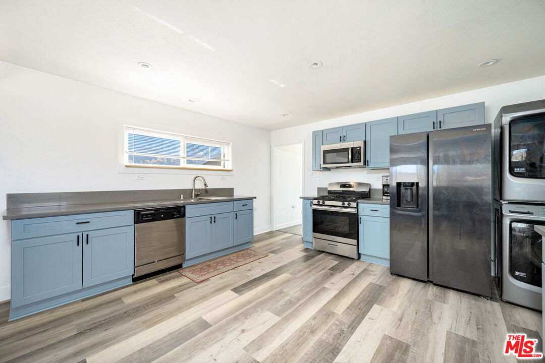 57157 Emerald Way Landers, CA 92285 - Photo 4 of 12 a kitchen with granite countertop stainless steel appliances and wooden cabinets