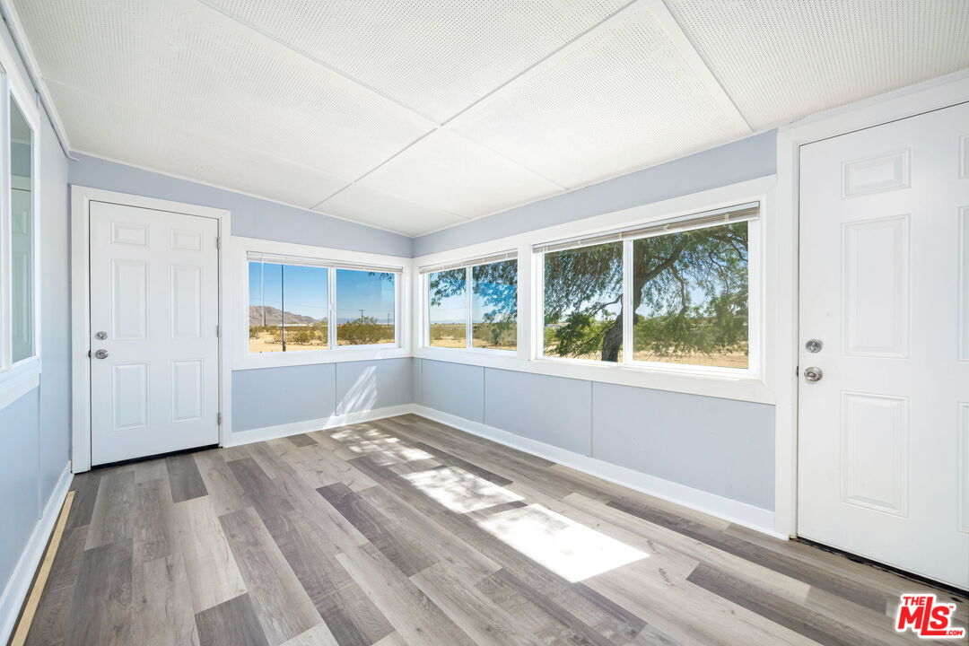 57157 Emerald Way Landers, CA 92285 - Photo 6 of 12 a view of empty room with wooden floor and fan