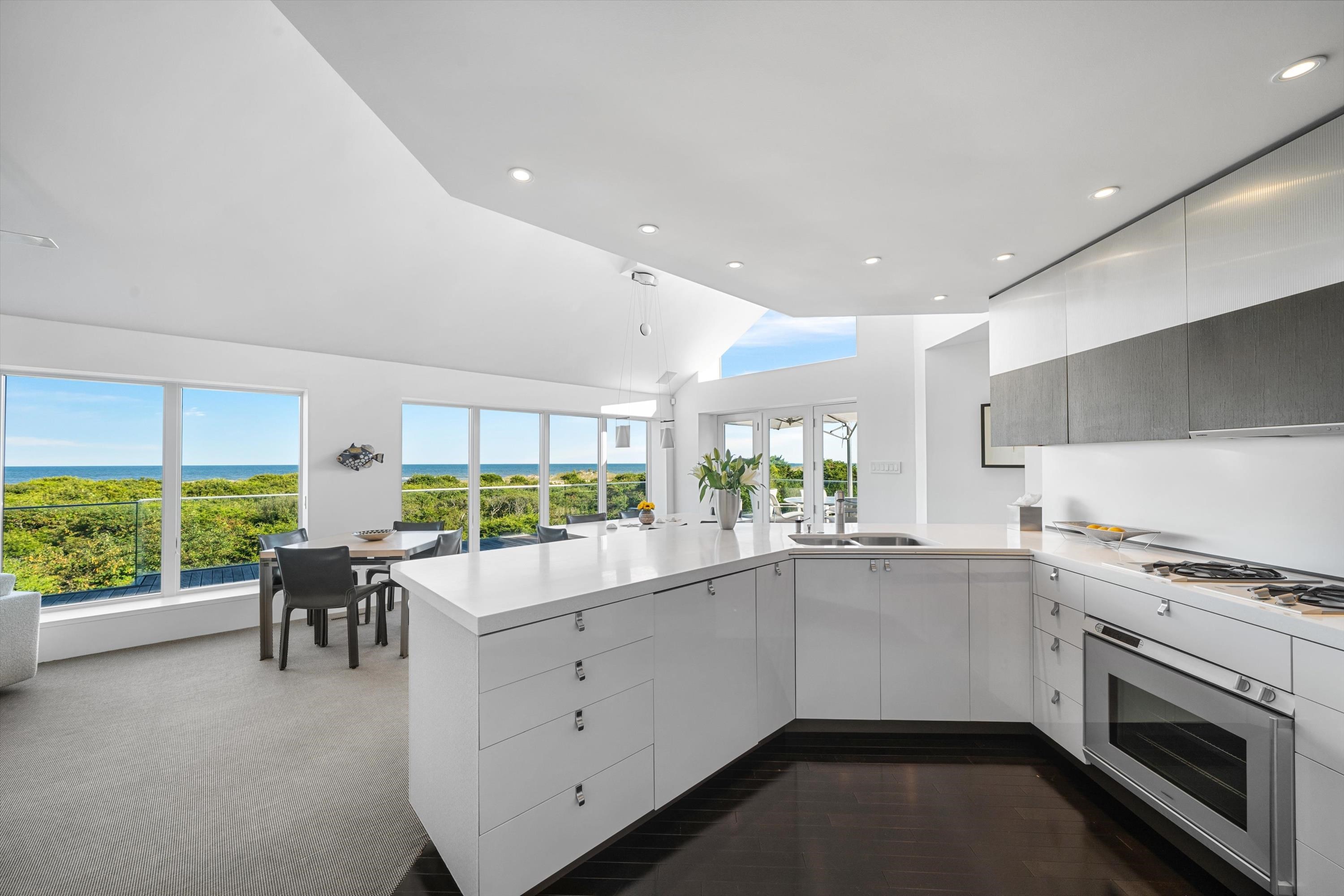 103 116th Street Stone Harbor, NJ 08247 - Photo 12 of 49 a kitchen with a table chairs stove and cabinets