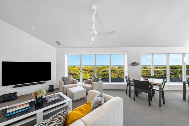 a kitchen with a table chairs and white cabinets