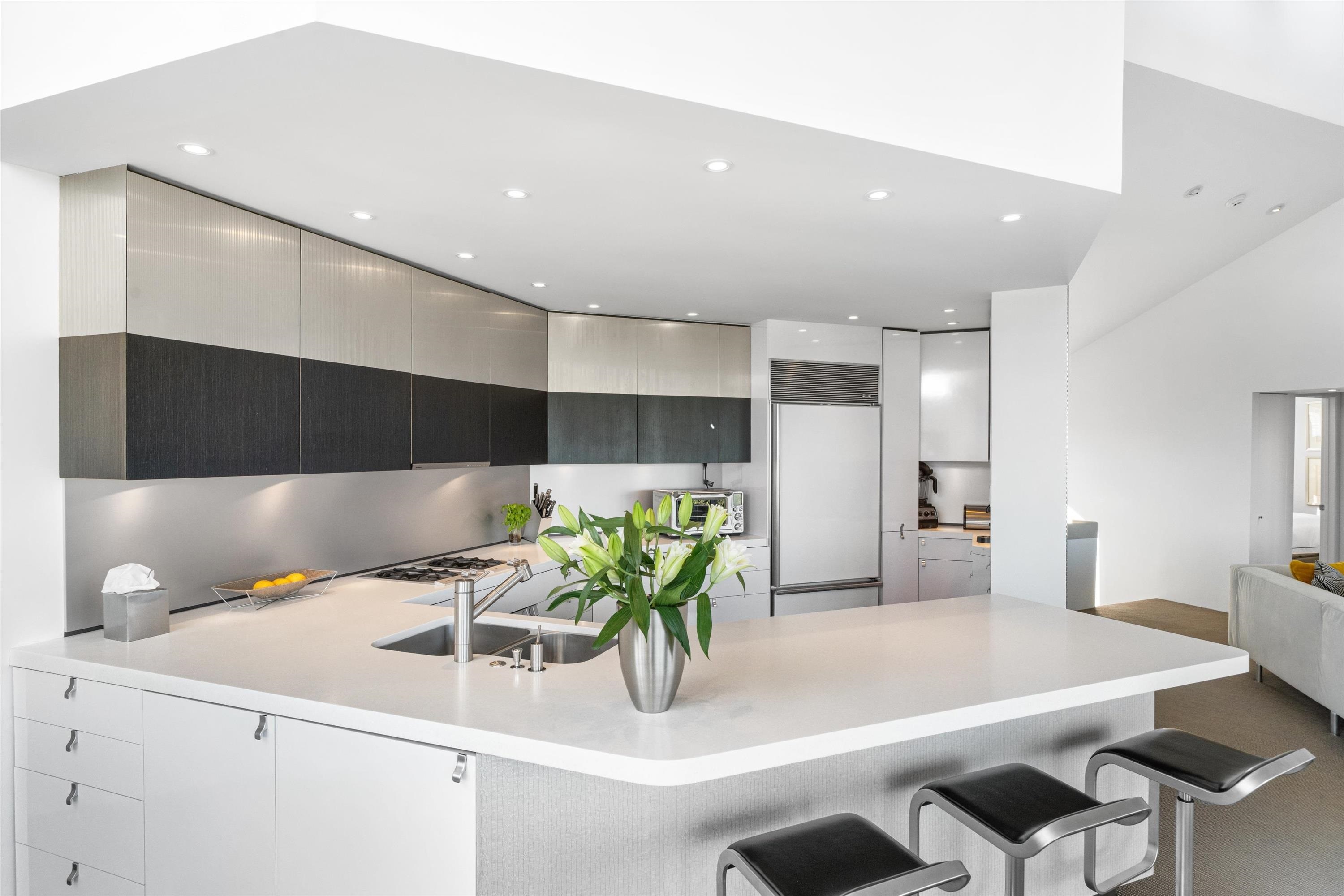 103 116th Street Stone Harbor, NJ 08247 - Photo 15 of 49 a kitchen with a table chairs and white cabinets