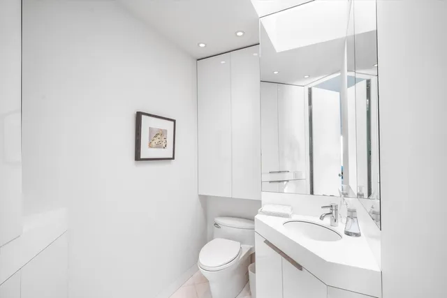 a bedroom with a bed and a dresser next to a window