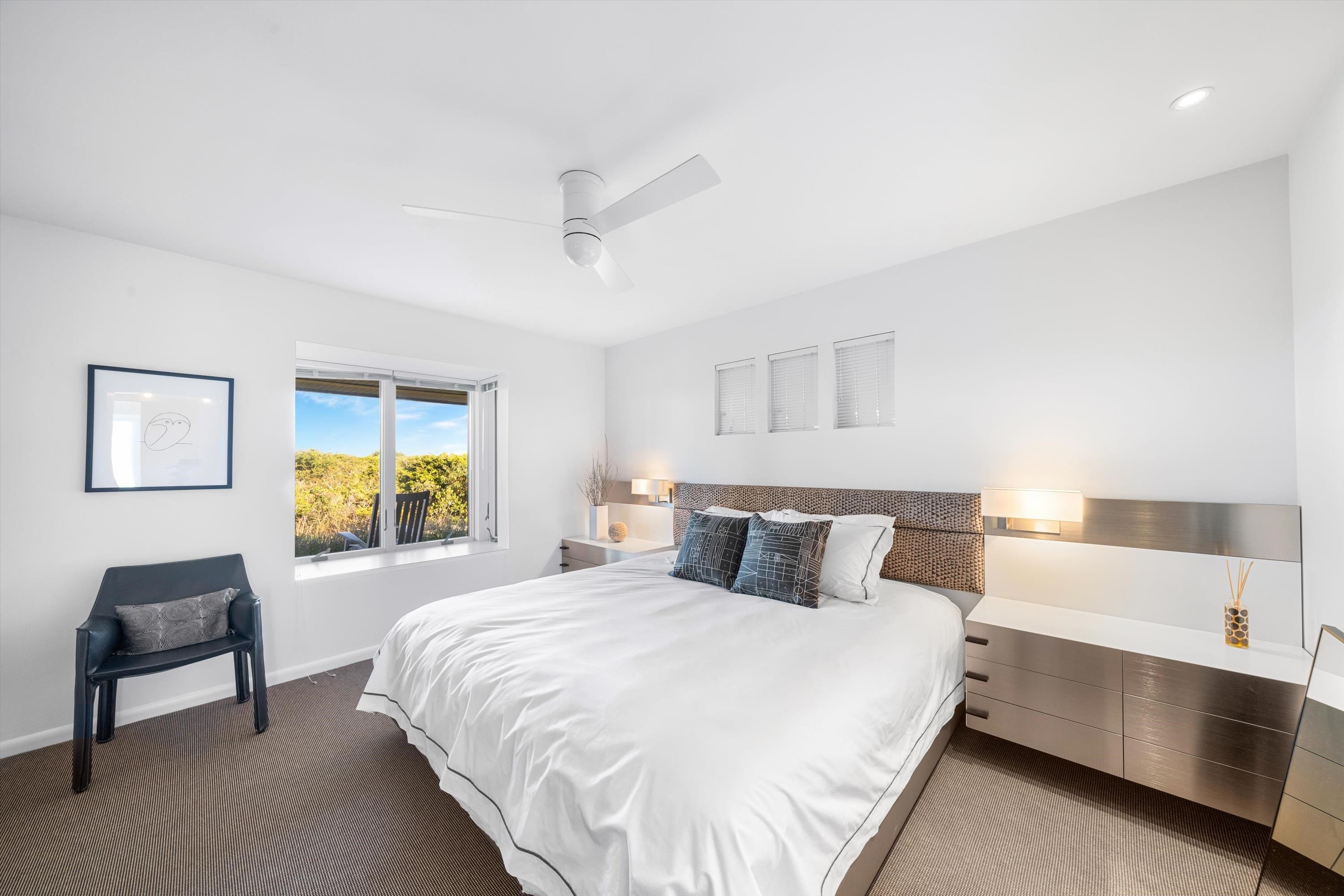 103 116th Street Stone Harbor, NJ 08247 - Photo 22 of 49 a bedroom with a bed and a dresser next to a window