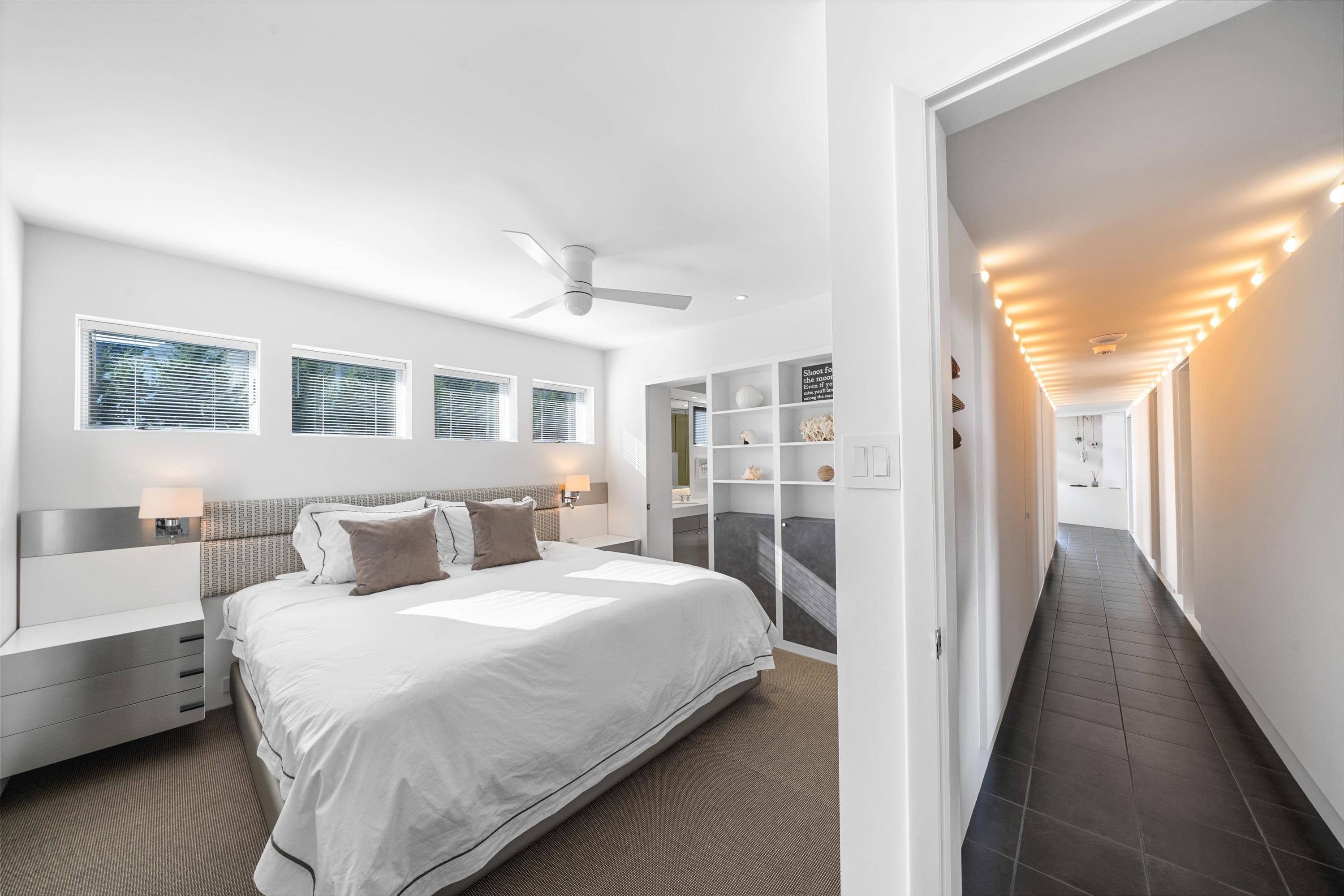 103 116th Street Stone Harbor, NJ 08247 - Photo 25 of 49 a bedroom with a large bed and a chandelier