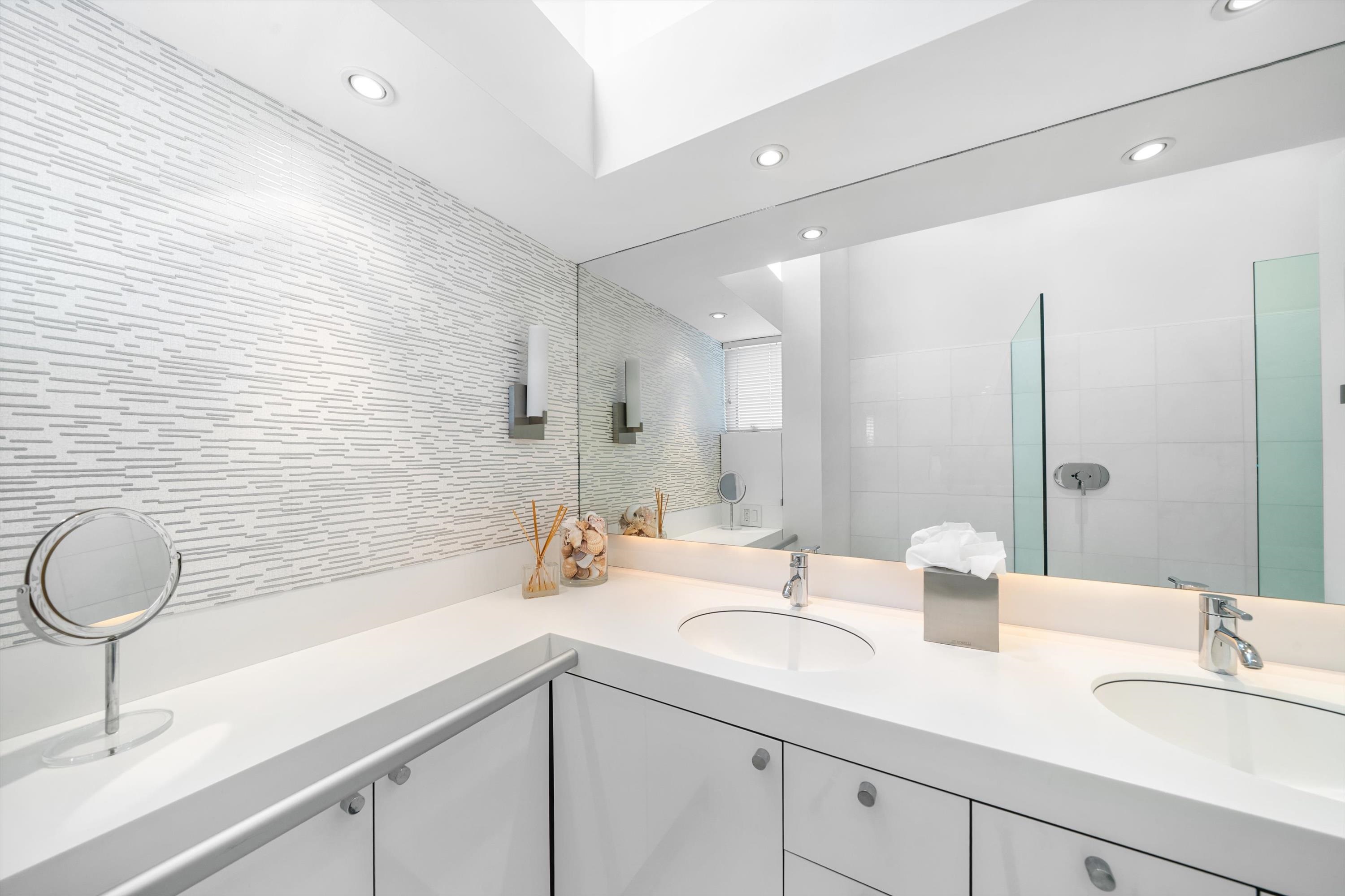 103 116th Street Stone Harbor, NJ 08247 - Photo 26 of 49 a bathroom with a double vanity sink a mirror and a bathtub
