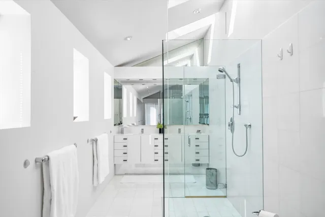 a bathroom with a shower sink and toilet