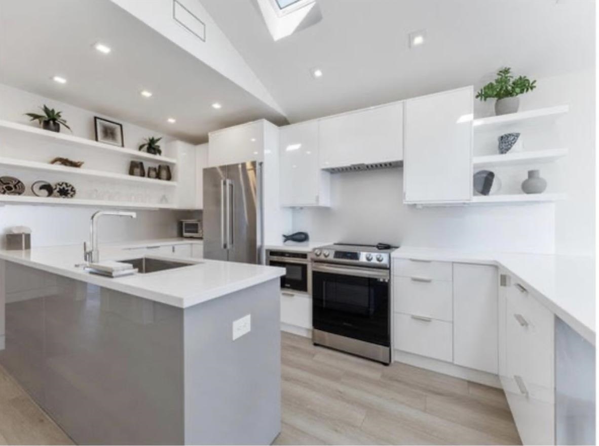 103 116th Street Stone Harbor, NJ 08247 - Photo 44 of 49 a kitchen with stainless steel appliances a sink stove and refrigerator