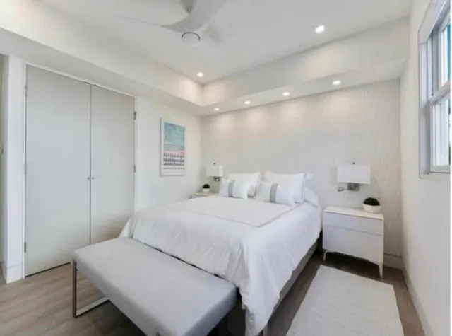 a view of a kitchen with white cabinets