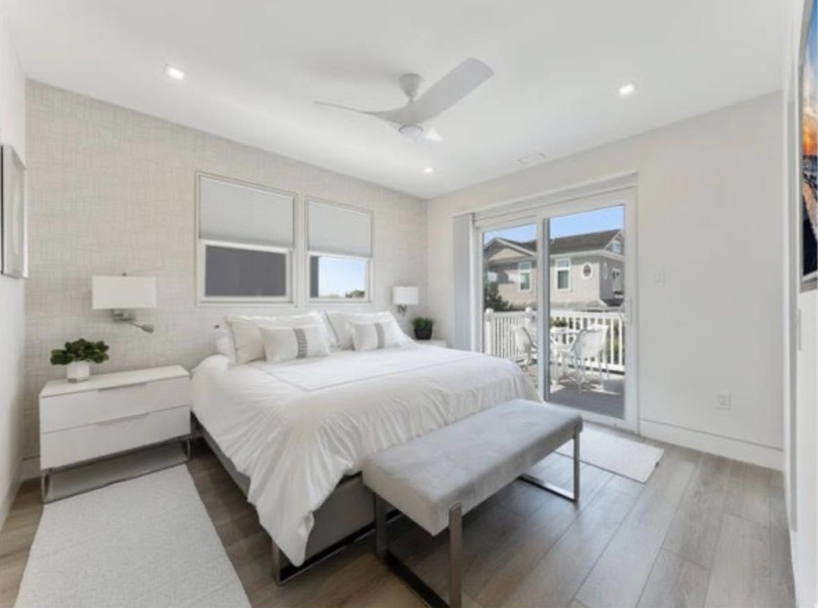 103 116th Street Stone Harbor, NJ 08247 - Photo 47 of 49 a spacious bedroom with a bed a couch and a bookshelf