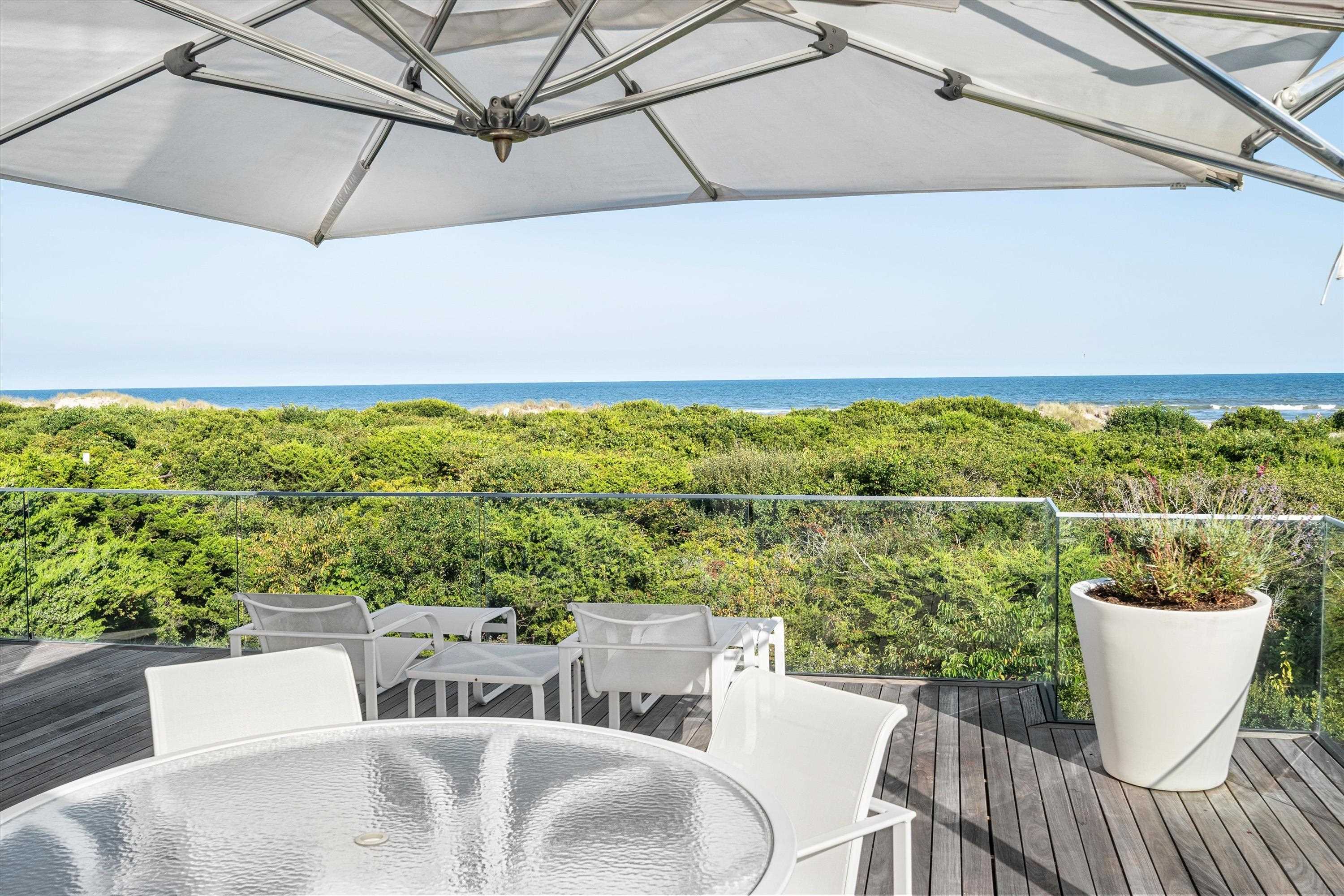 103 116th Street Stone Harbor, NJ 08247 - Photo 8 of 49 a view of a patio with a table and chairs