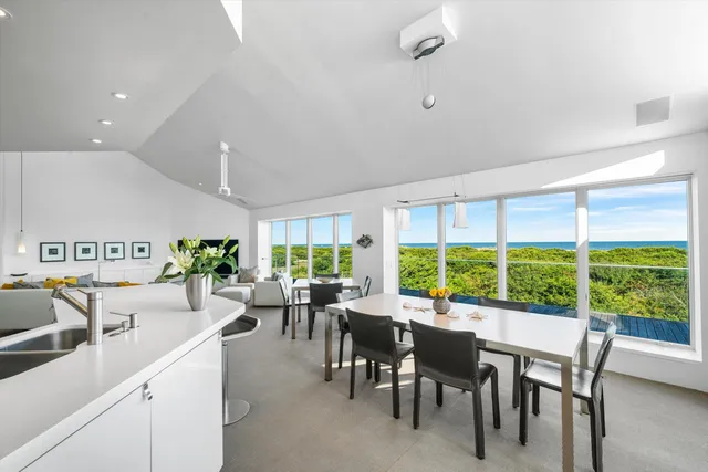 a kitchen with a table chairs stove and cabinets