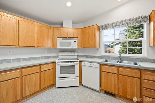 a kitchen with sink cabinets and window