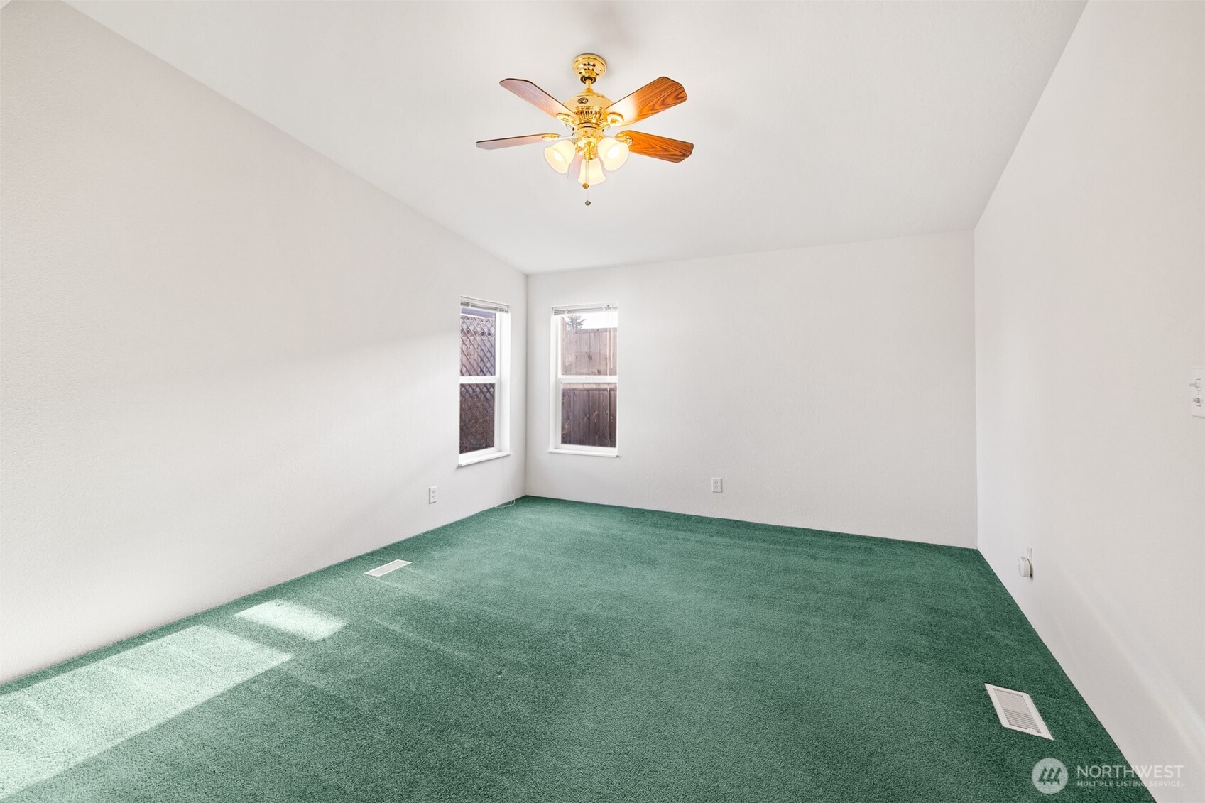 507 North 7th Avenue Sequim, WA 98382 - Photo 16 of 40 a view of a room with a ceiling fan and carpet