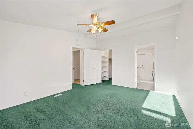a view of a room with a window and a ceiling fan