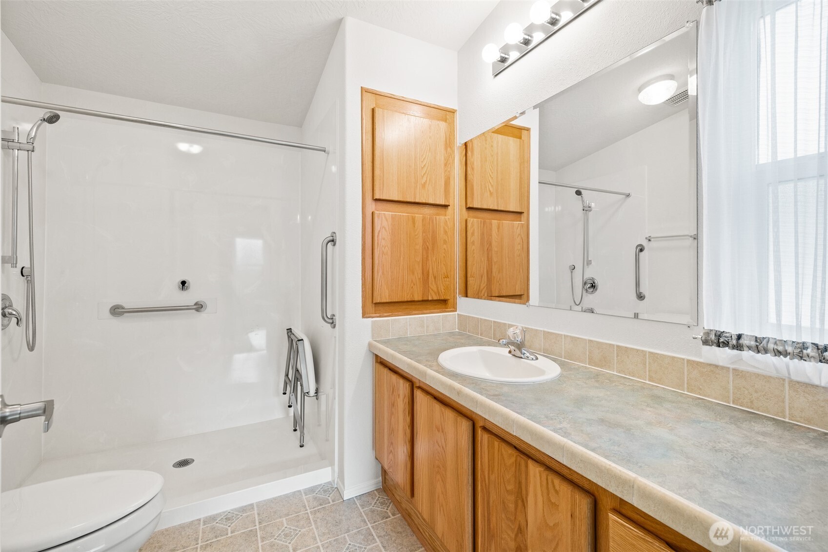 507 North 7th Avenue Sequim, WA 98382 - Photo 19 of 40 a bathroom with a granite countertop sink toilet and shower