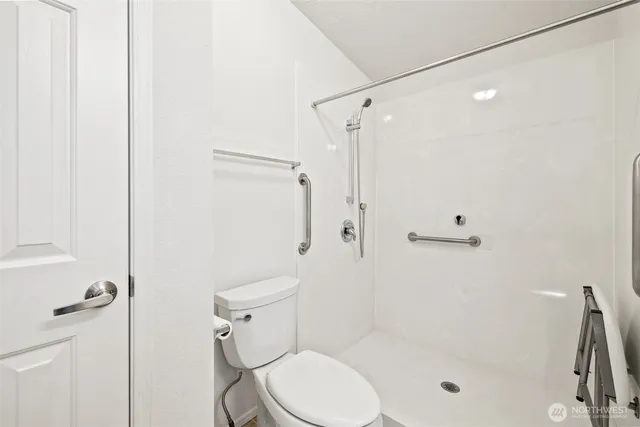 a white toilet sitting next to a bath tub shower