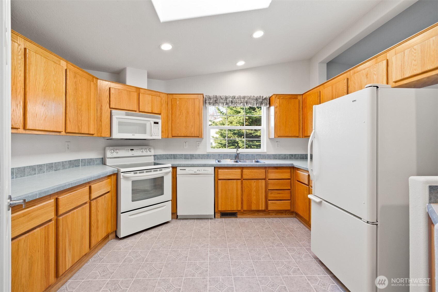 507 North 7th Avenue Sequim, WA 98382 - Photo 8 of 40 a kitchen with stainless steel appliances granite countertop a refrigerator sink and stove