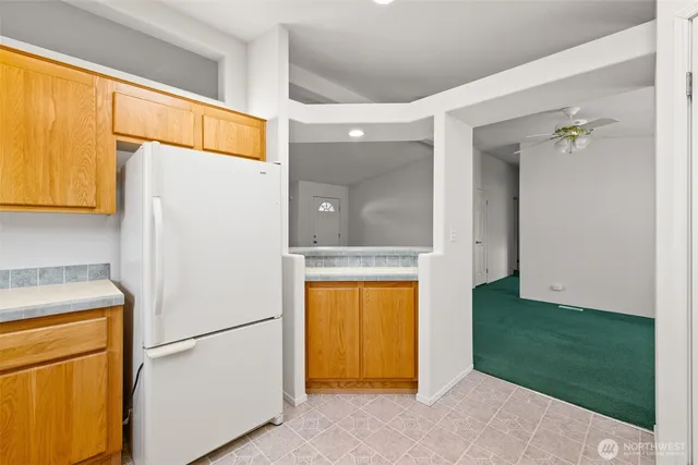 a white refrigerator freezer sitting in a kitchen