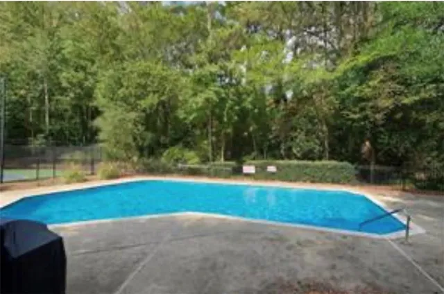 a view of pool with green yard