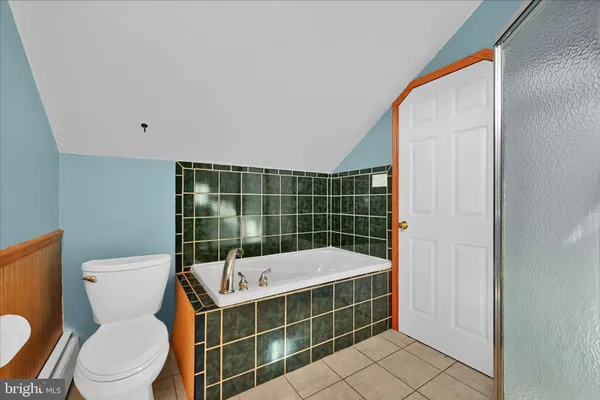 a bathroom with a toilet a sink and shower