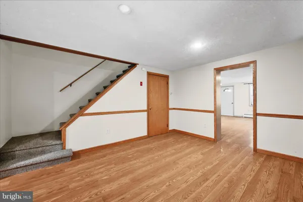 a view of an empty room with wooden floor