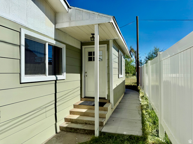 255 West Main Street Mount Pleasant, UT 84647 - Photo 33 of 35 Entryway featuring a covered porch, durable siding, multi-pane door, and concrete steps