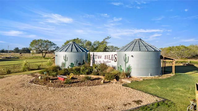 a view of a house with a yard and sitting area