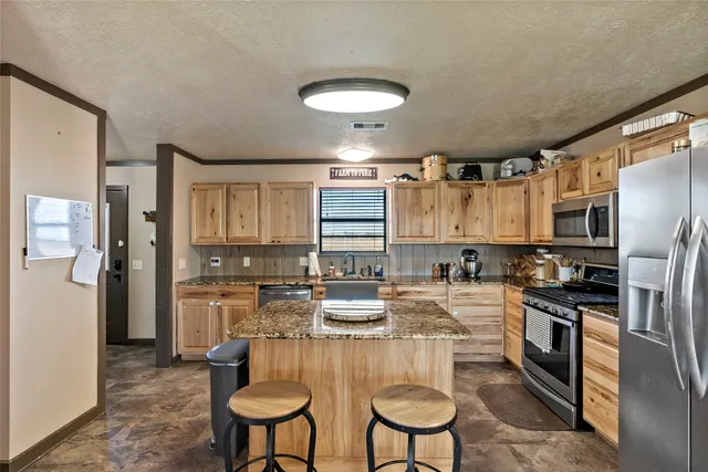 a kitchen with refrigerator and cabinets