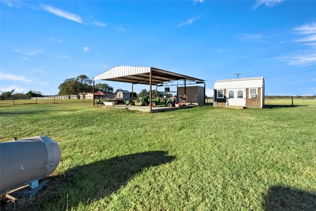 a view of a house with a yard and sitting area