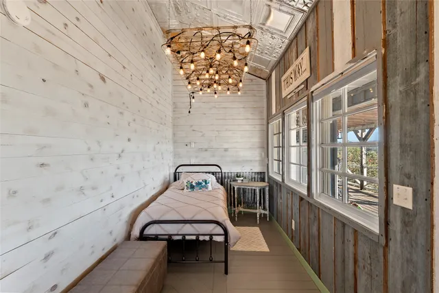 a bedroom with a bed and a chandelier