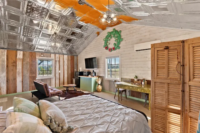 a bedroom with furniture and a large window