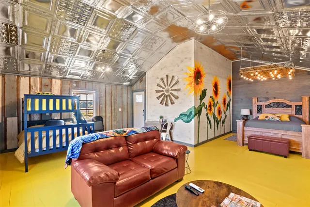 a bedroom with a bed and a chandelier