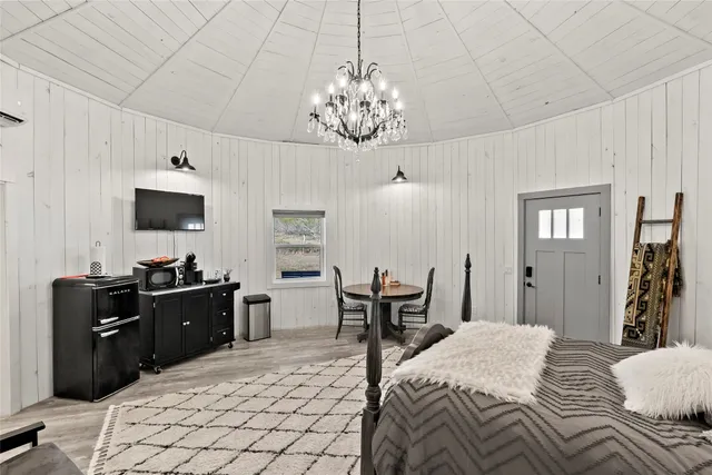 a bedroom with furniture and a chandelier