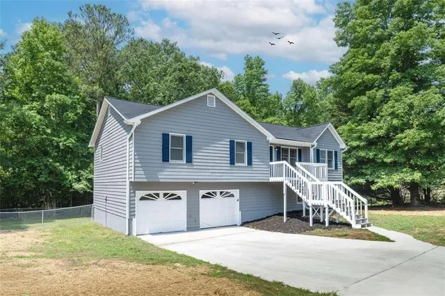 a view of a house with a yard and sitting area