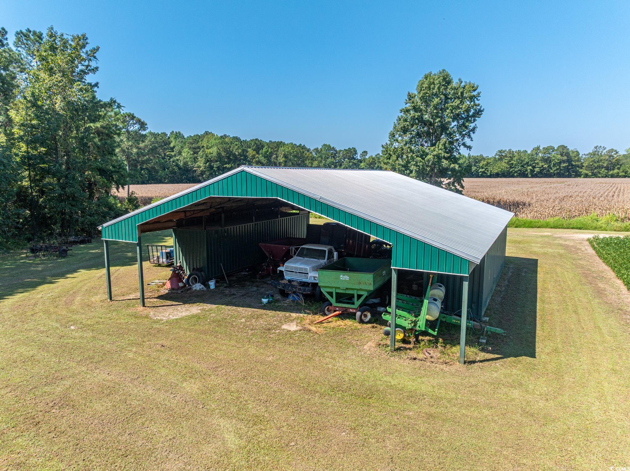 0 No Where Road Clarendon, NC 28432 - Photo 5 of 22 View of pole building with a lawn, a detached carport, a view of countryside, and agricultural plots