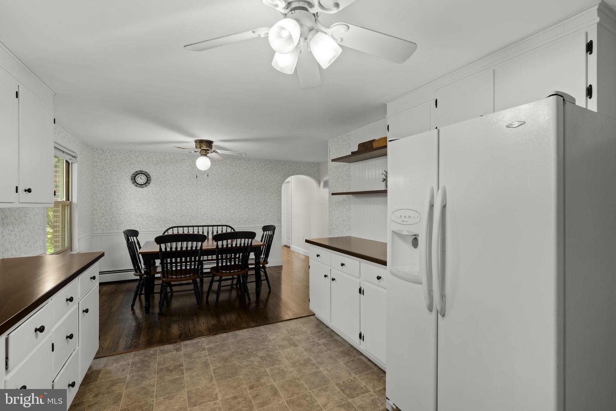 1160 Narvon Road Narvon, PA 17555 - Photo 36 of 64 a kitchen with granite countertop a refrigerator a stove a dining table and chairs with wooden floor