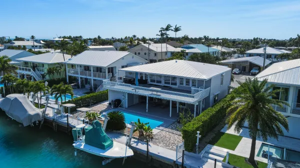 a aerial view of a house with swimming pool and furniture