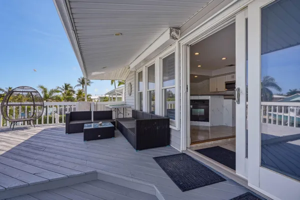 a kitchen with stainless steel appliances a refrigerator a sink a stove and white cabinets