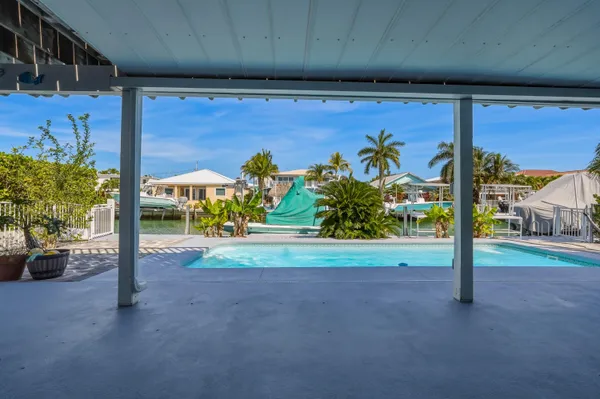 a swimming pool with outdoor seating and yard