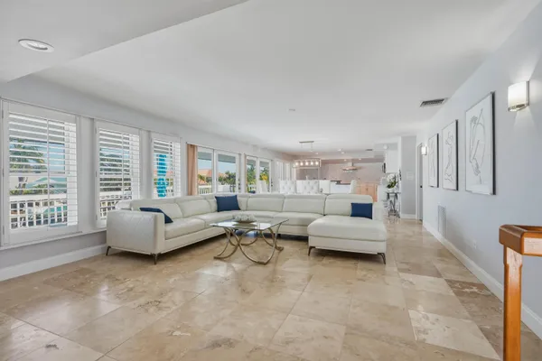 a living room with furniture and floor to ceiling window