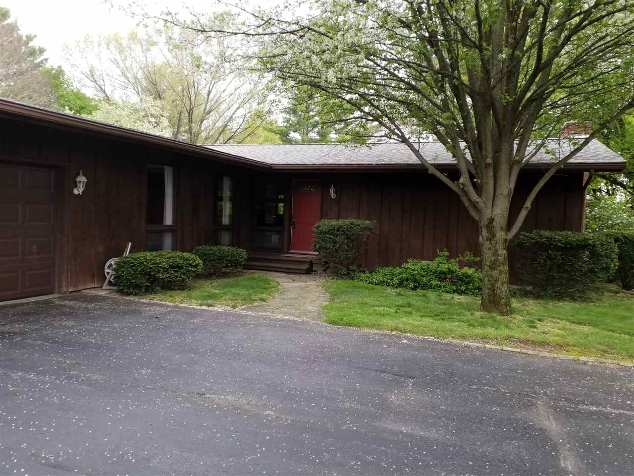 1548 Riverside Road Belvidere, IL 61008 - Photo 1 of 21 a view of a house with a large tree and a yard