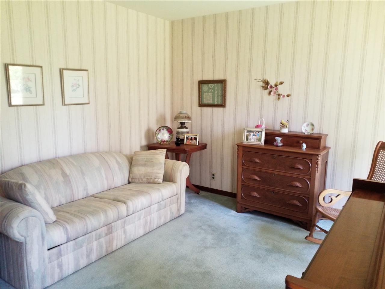 1548 Riverside Road Belvidere, IL 61008 - Photo 12 of 21 a living room with furniture and a baby crib