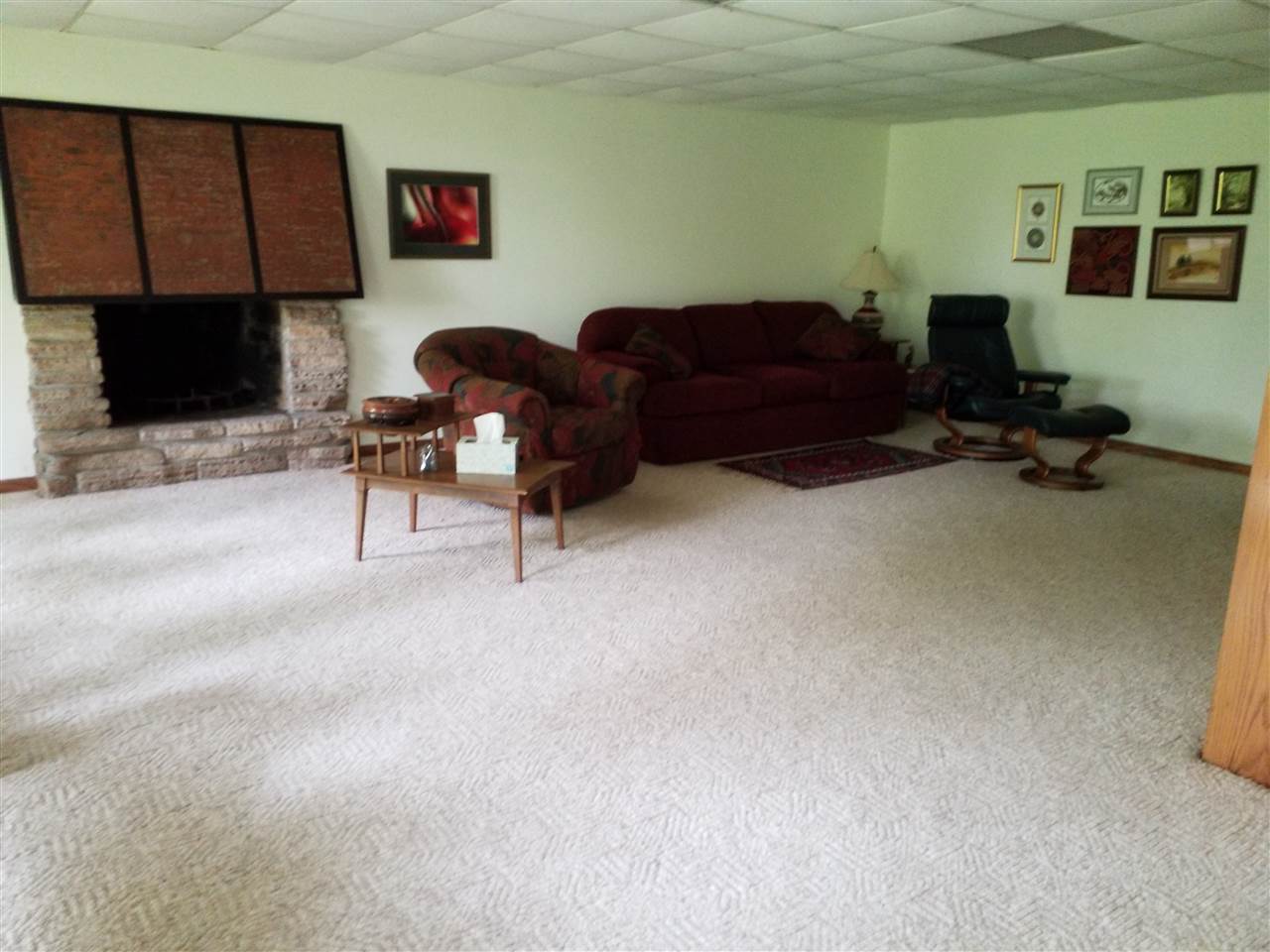 1548 Riverside Road Belvidere, IL 61008 - Photo 15 of 21 a living room with furniture a flat screen tv and a fireplace