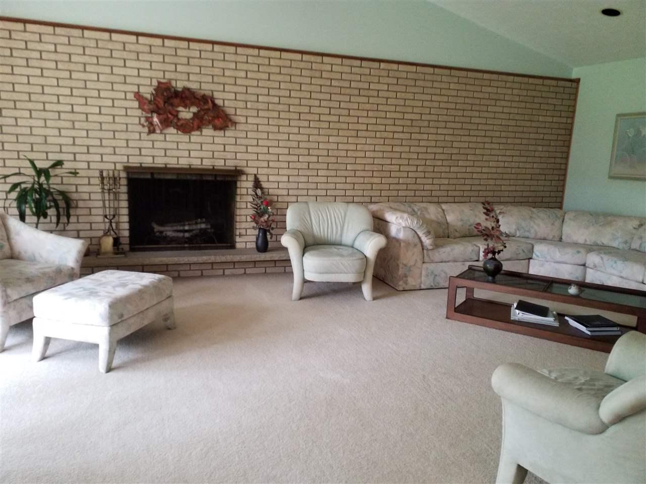 1548 Riverside Road Belvidere, IL 61008 - Photo 3 of 21 a living room with furniture a flat screen tv and a fireplace