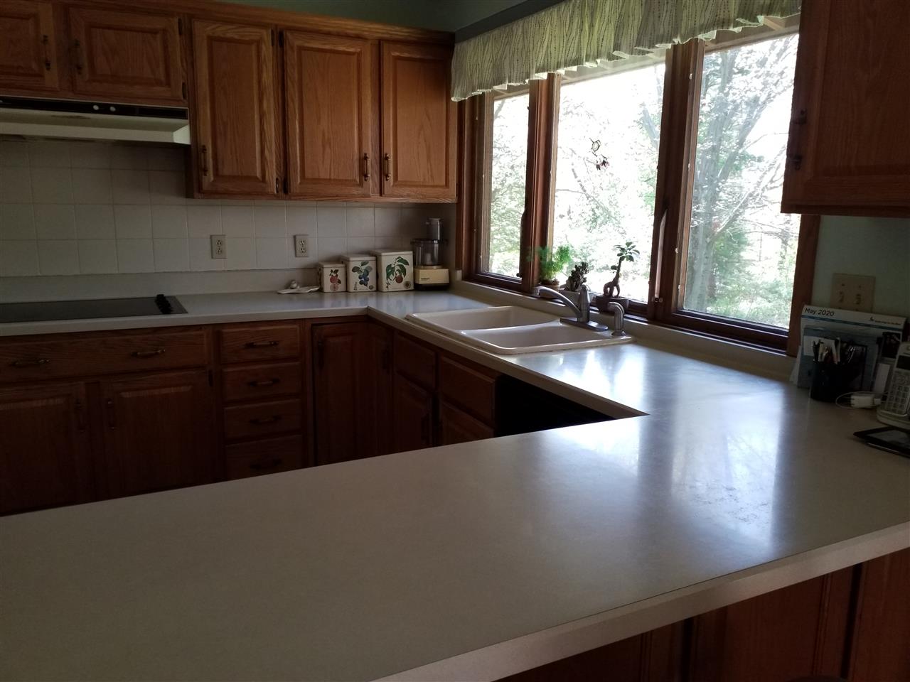 1548 Riverside Road Belvidere, IL 61008 - Photo 6 of 21 a kitchen with stainless steel appliances a sink window and cabinets