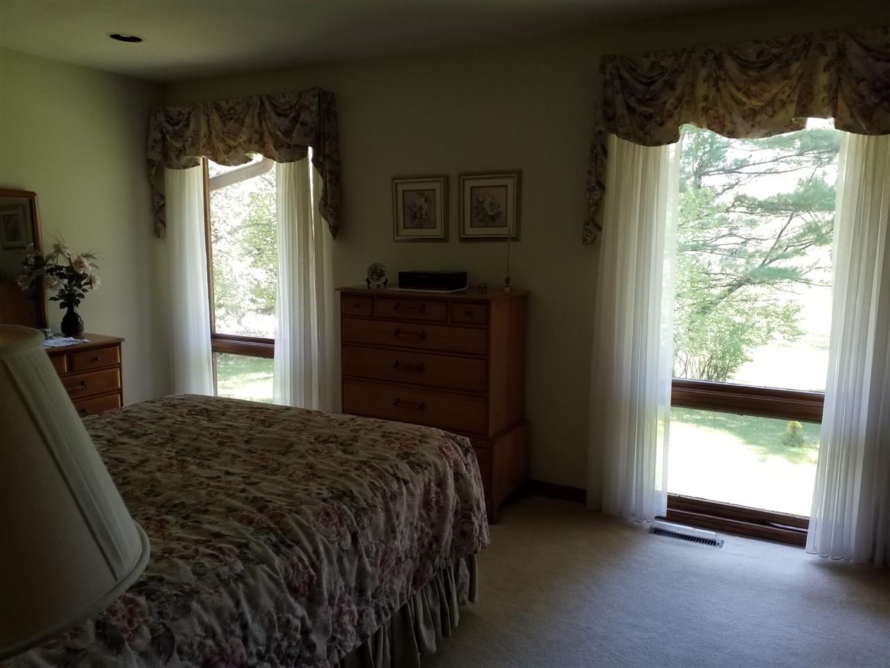 1548 Riverside Road Belvidere, IL 61008 - Photo 10 of 21 a bedroom with a bed and a window